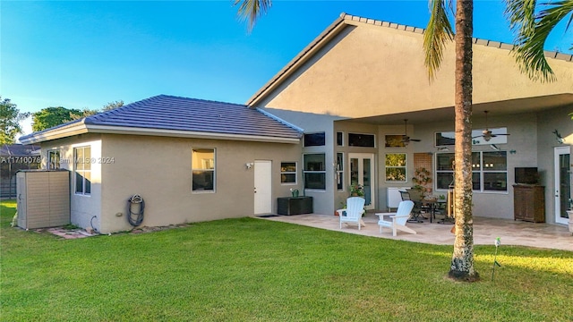 back of house featuring a patio area and a yard