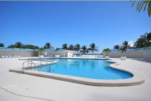 community pool with a patio area