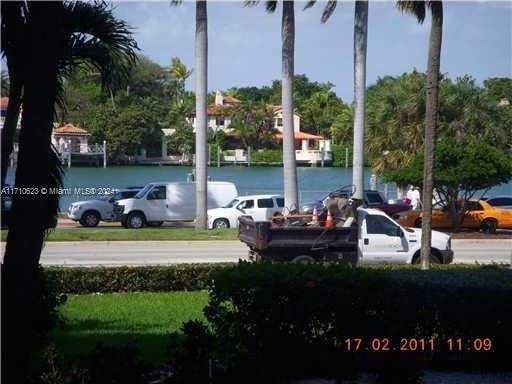 view of parking / parking lot featuring a water view