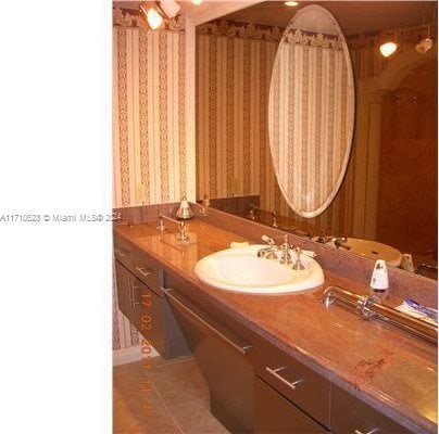 bathroom with tile patterned floors and vanity