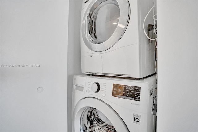 laundry area featuring stacked washing maching and dryer