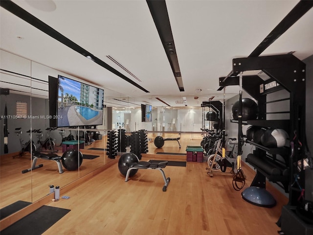 workout area with hardwood / wood-style flooring