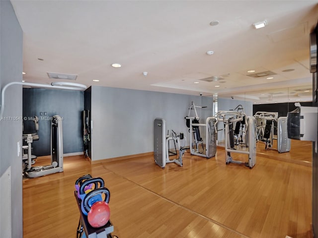 exercise room with wood-type flooring