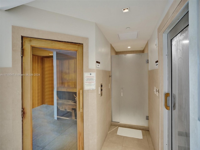 hall featuring light tile patterned floors