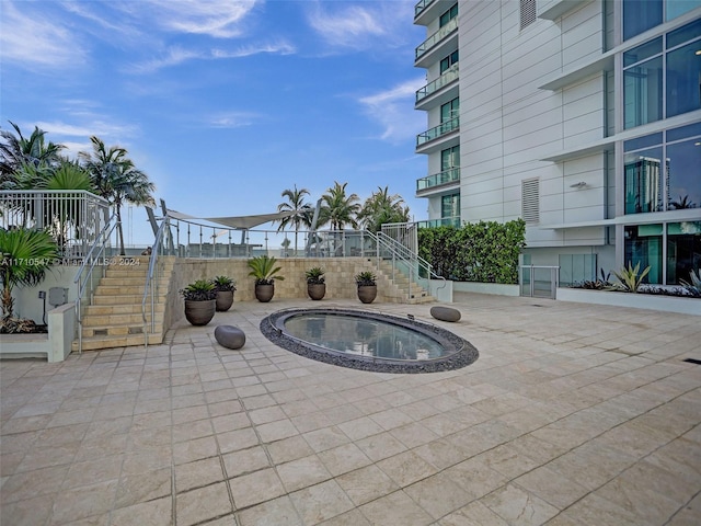 view of patio featuring an in ground hot tub