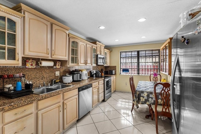 kitchen featuring sink, light tile patterned floors, light brown cabinetry, tasteful backsplash, and stainless steel appliances