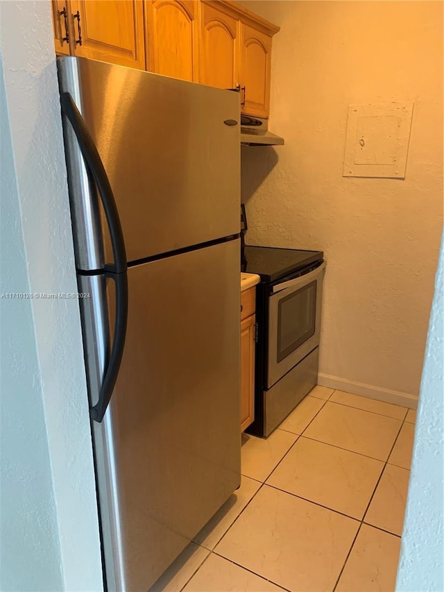 kitchen with appliances with stainless steel finishes and light tile patterned floors