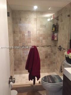 bathroom with vanity and tiled shower