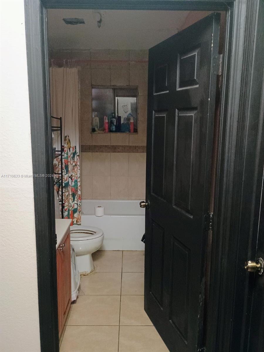 bathroom with tile patterned floors, vanity, and toilet