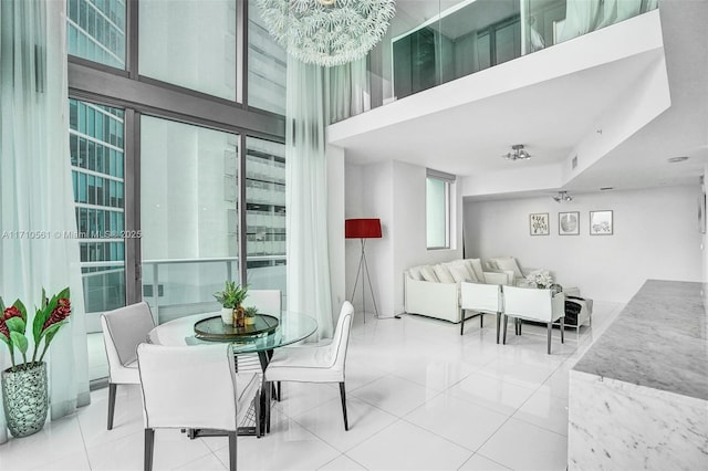 dining space featuring a towering ceiling and tile patterned floors