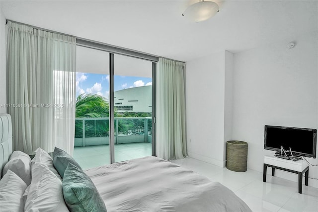 bedroom featuring access to exterior and a wall of windows