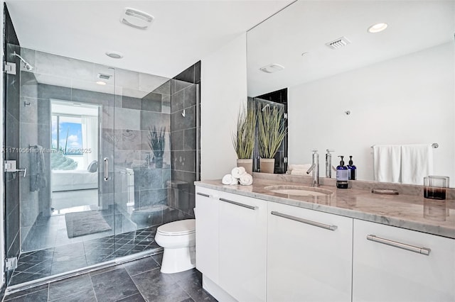 bathroom with toilet, vanity, and an enclosed shower