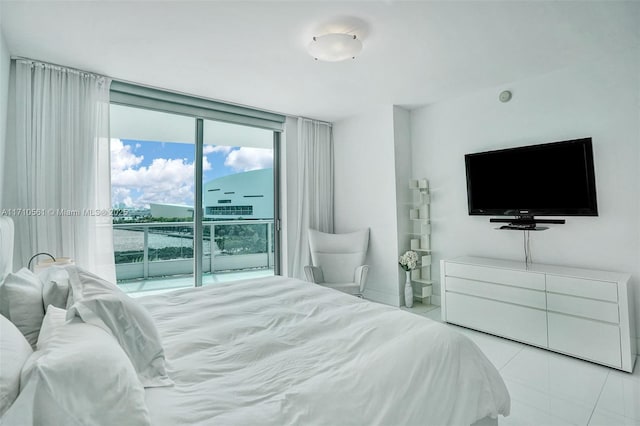 bedroom with access to exterior, expansive windows, and light tile patterned flooring