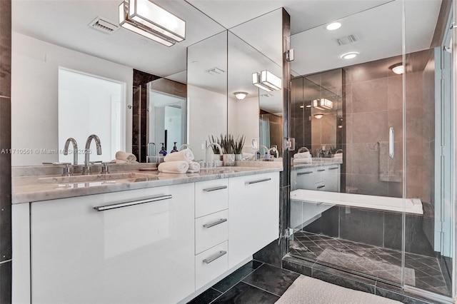 bathroom featuring vanity and a shower with shower door