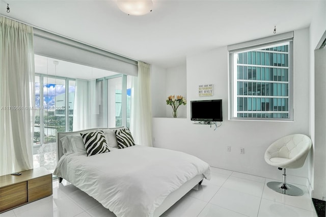 bedroom featuring expansive windows and light tile patterned flooring