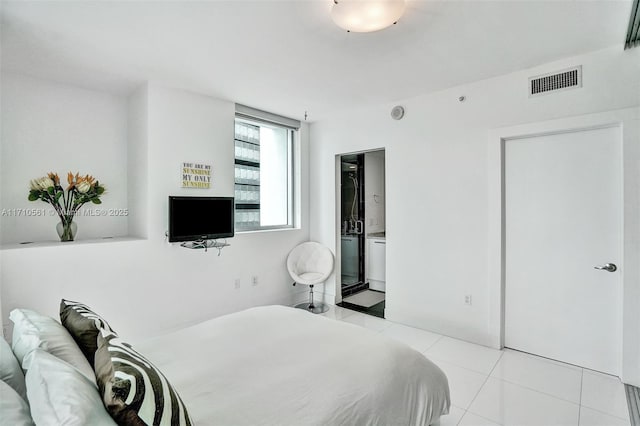 tiled bedroom featuring connected bathroom