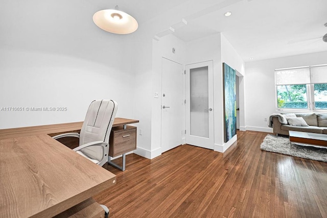 home office with dark hardwood / wood-style flooring