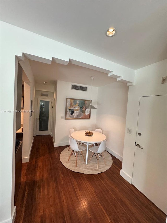 dining space featuring dark hardwood / wood-style floors