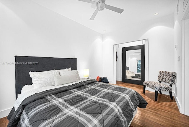 bedroom with ceiling fan and wood-type flooring