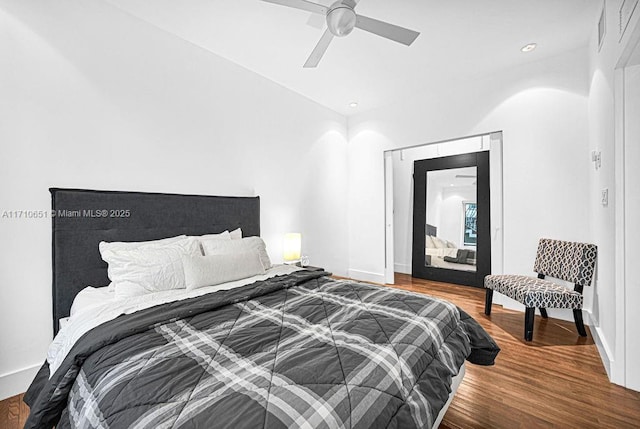 bedroom with ceiling fan and wood-type flooring