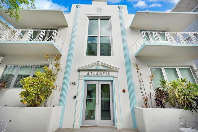 entrance to property featuring french doors and a balcony