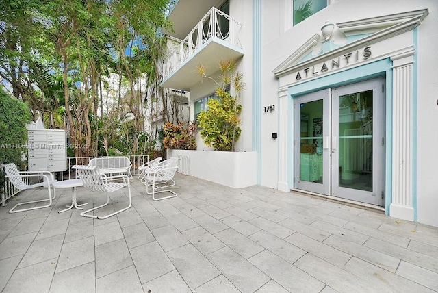 view of patio / terrace with french doors and a balcony