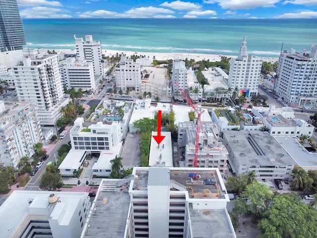 drone / aerial view featuring a water view and a view of the beach