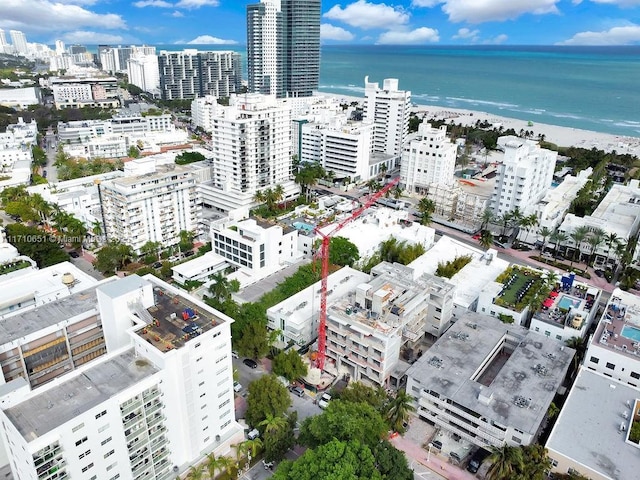 drone / aerial view featuring a view of the beach and a water view