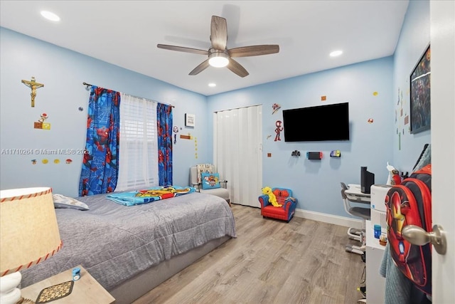 bedroom featuring ceiling fan, light wood-type flooring, and a closet