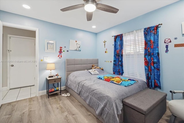 bedroom with ceiling fan and light hardwood / wood-style flooring