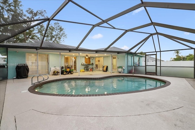 view of pool featuring a patio and glass enclosure