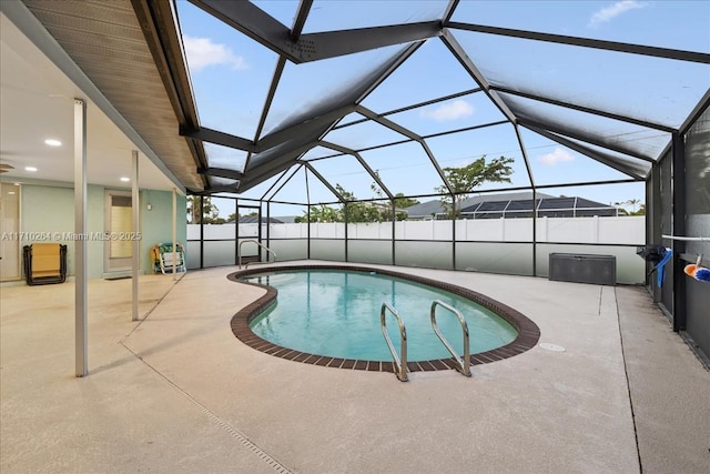 view of swimming pool with a lanai and a patio area