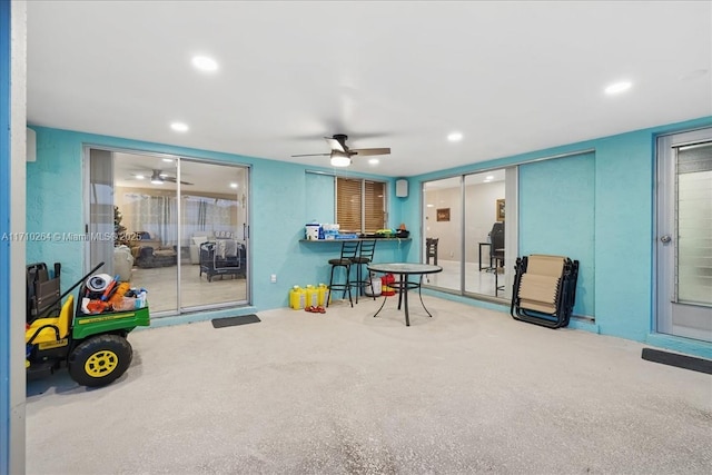 playroom with ceiling fan and carpet flooring