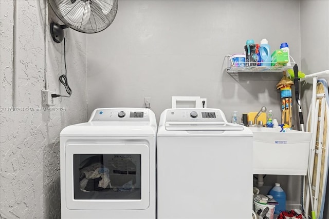 washroom with washer and dryer and sink