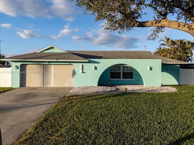 ranch-style house with a garage and a front lawn