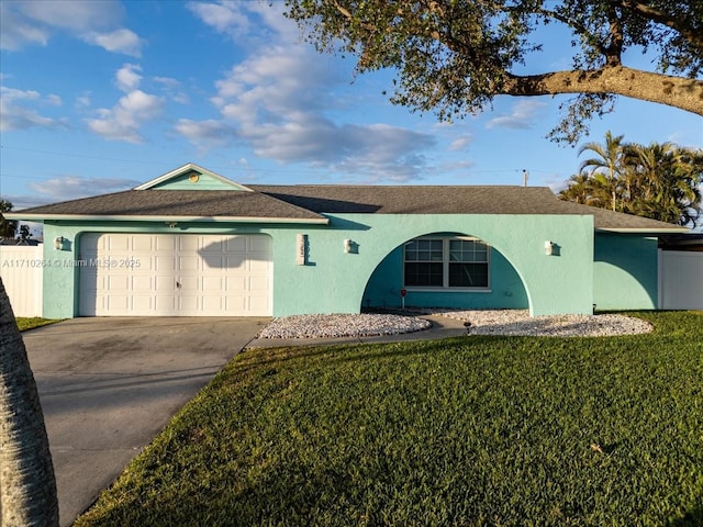 ranch-style house featuring a front yard and a garage