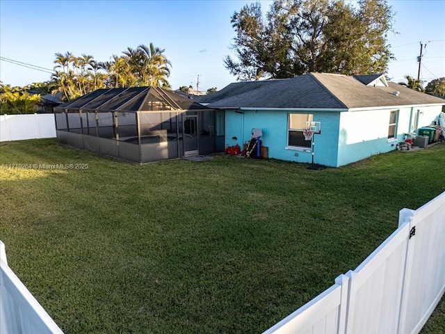 back of property featuring cooling unit and a lawn