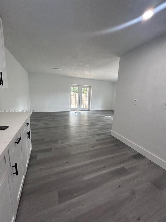 unfurnished living room with french doors and dark hardwood / wood-style floors