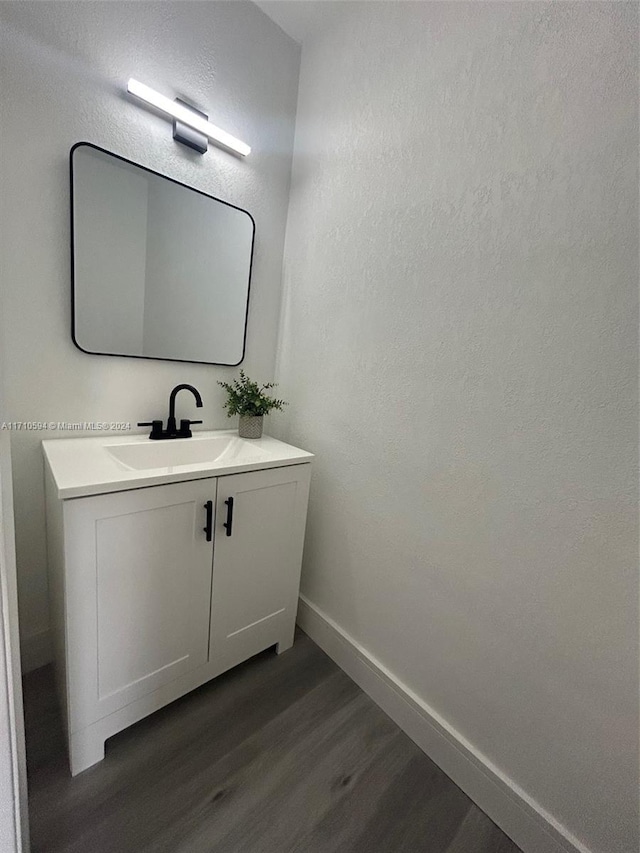 bathroom with hardwood / wood-style floors and vanity