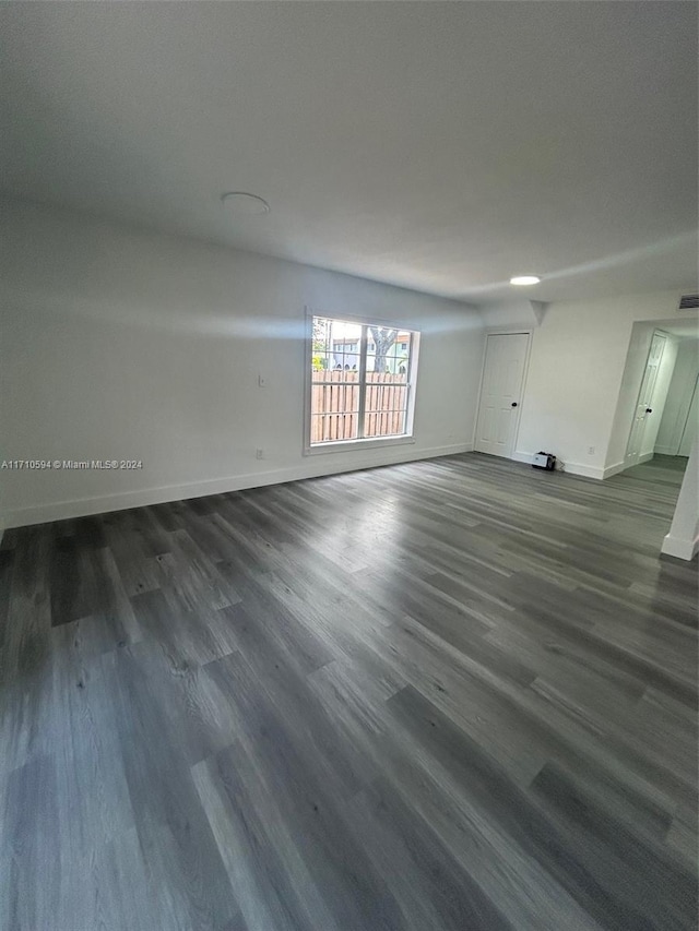 unfurnished room featuring dark wood-type flooring