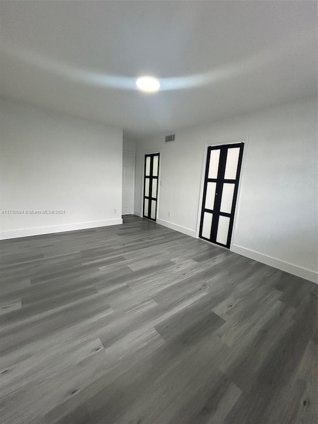 spare room featuring dark hardwood / wood-style flooring