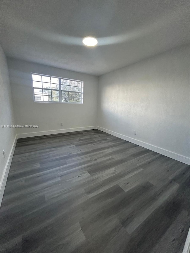 spare room with dark hardwood / wood-style flooring