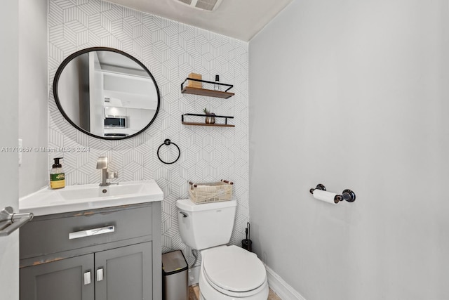 bathroom featuring vanity and toilet