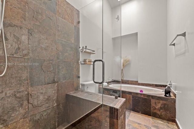 bathroom with separate shower and tub and toilet