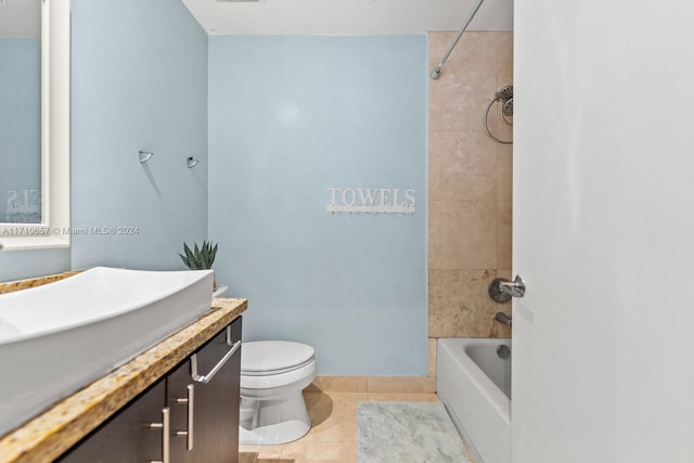 full bathroom featuring tile patterned floors, tiled shower / bath combo, toilet, and vanity