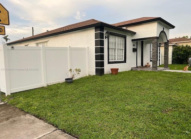 view of side of property with a lawn