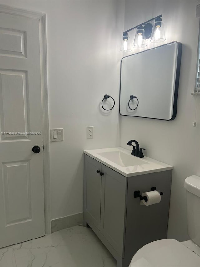 bathroom featuring vanity and toilet