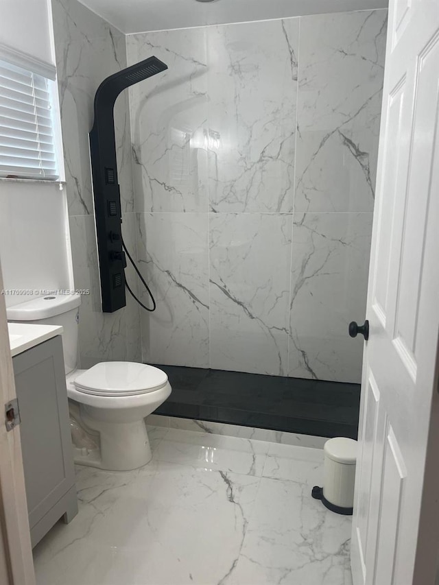 bathroom with vanity, a shower, and toilet