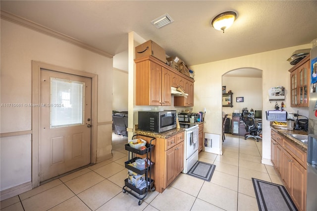 kitchen featuring white electric range, light tile patterned floors, ornamental molding, and dark stone counters