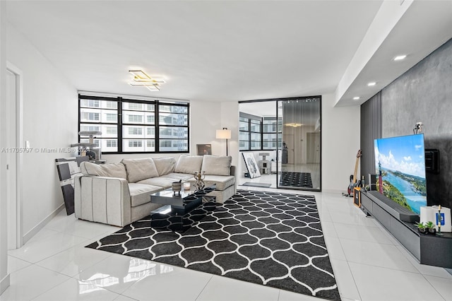 living room with expansive windows and light tile patterned flooring